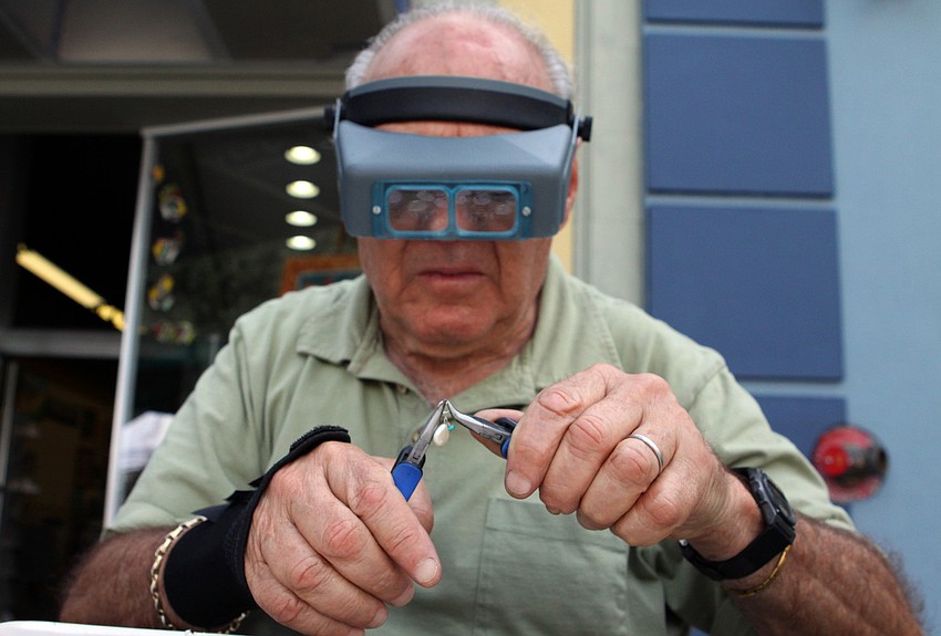 Arie Lilienthan, co-owner of Inspiration, works on making some jewelry Sunday, Oct. 16 on Main Street.