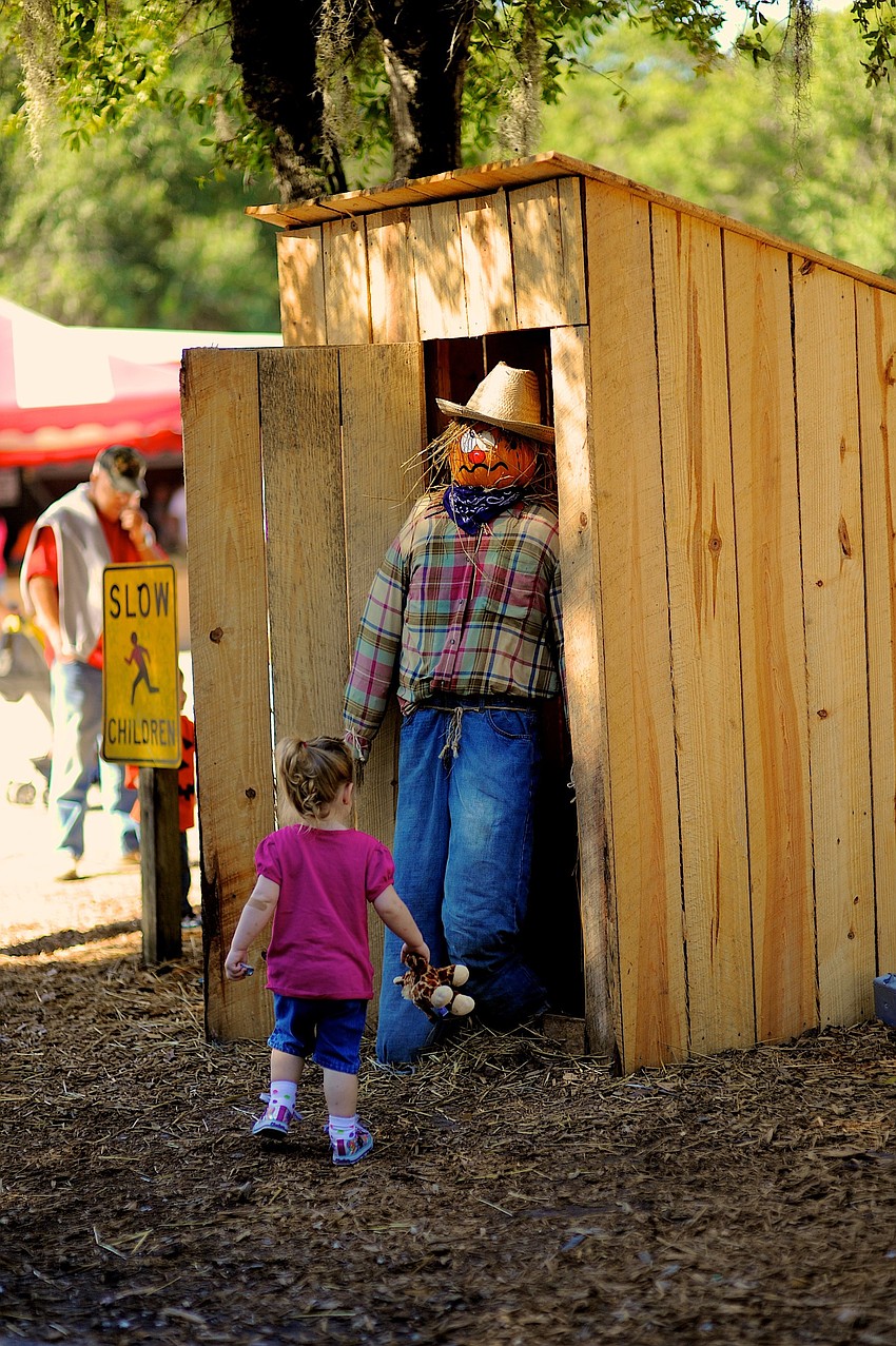 East County resident Mallory Bewley, 2, wasnâ€™t sure what to make of the scarecrow.