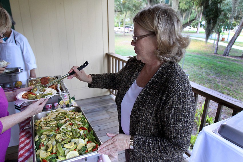 Carolyn Heath of the Broadway Bar serves up some pasta on the back porch of the Bidwell-Wood House, Tuesday, Oct. 25, as part of the Owen Burns Celebration Honoring John Hamilton Gillespie Week.