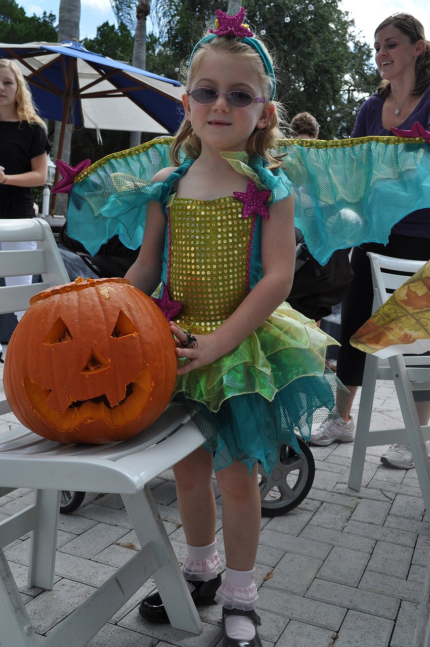 Grace Frazier poses with her jack-o-lantern