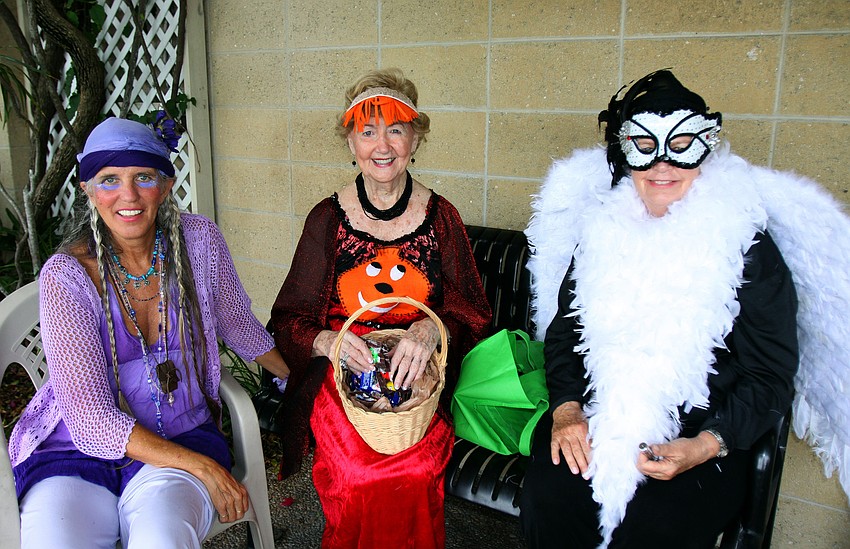Jill Evans, Jeanene Kortjohn and Diane Erne dressed up and handed out candy, Monday, Oct. 31, during the Safe Kids trick-or-treating event in Siesta Key Village.