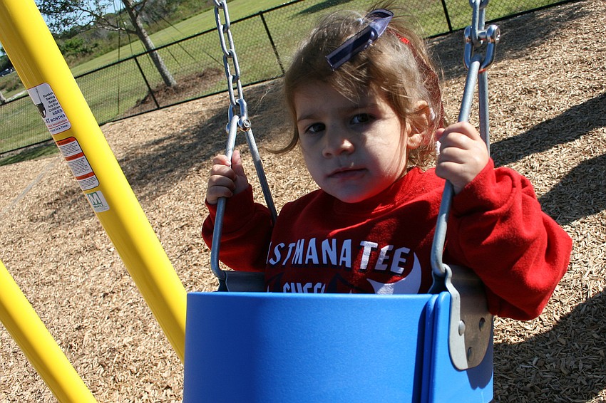 Riley Myclavic, 2, took a ride on the swings.