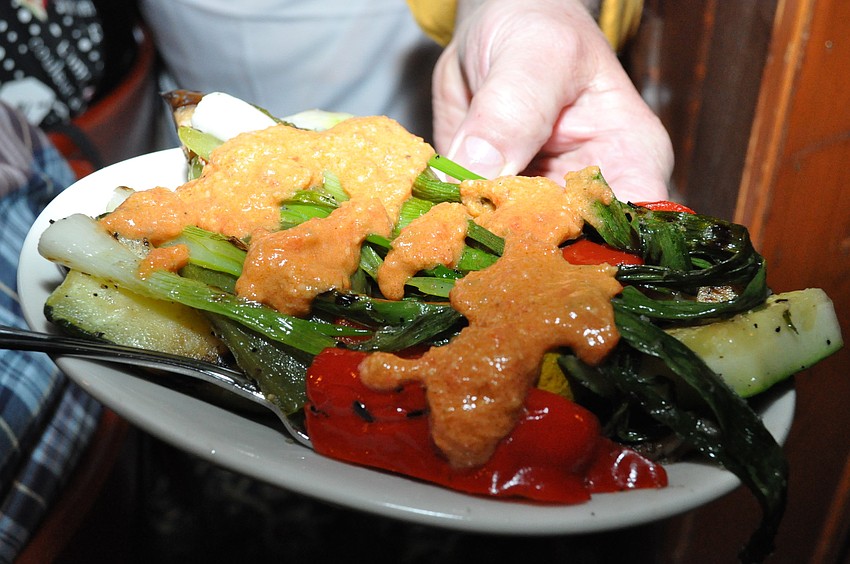 This tapas is the Grilled Vegetable Romesco, which are grilled mixed vegetables covered in a spicy red pepper, tomato and garlic sauce.