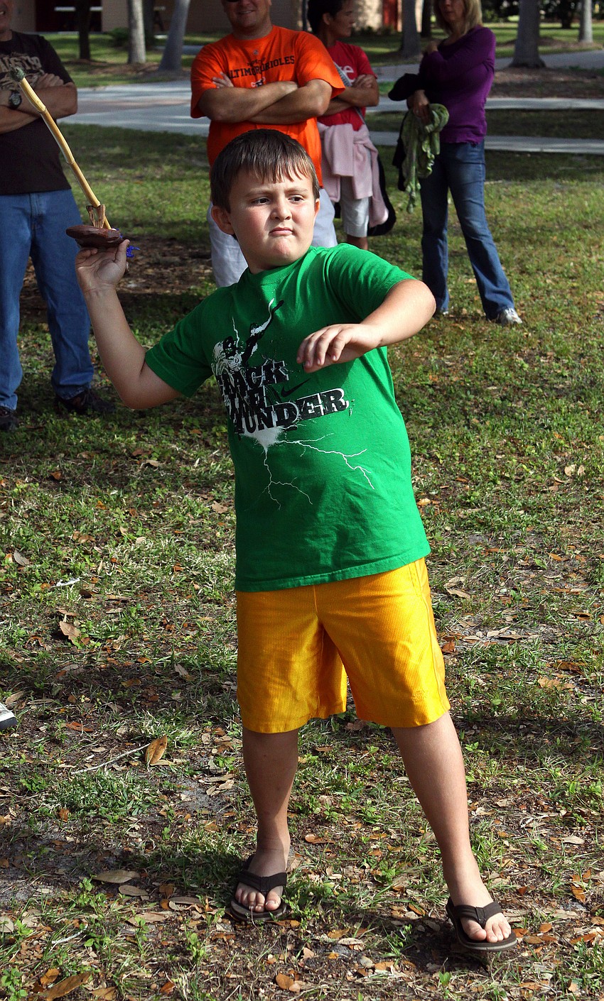 William Barrett, 8, prepares to throw an arrow with an atlatl, Saturday, Dec. 3, during Fruitville Elementary's junior archaeology day at New College's Public Archaeology Lab.
