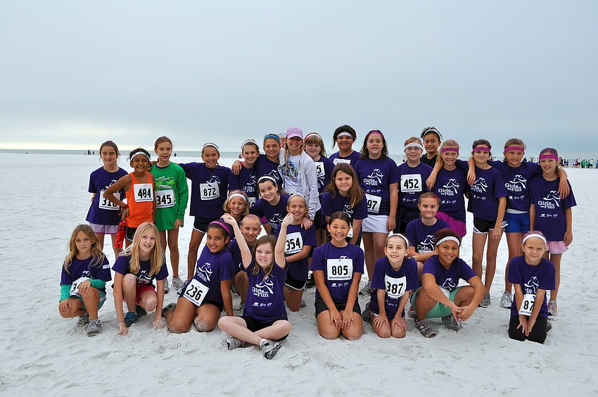 Girls Inc.â€™s Girls on the run pose together before heading off to run in the Sandy Claws 5K, Saturday, Dec. 10 on Siesta Key Beach.