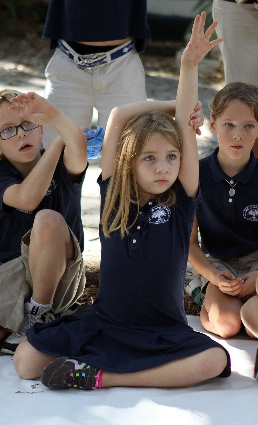 Peyton Wells, 7, raises her hand to ask Brian Wigelsworth a question about sand sculpting.