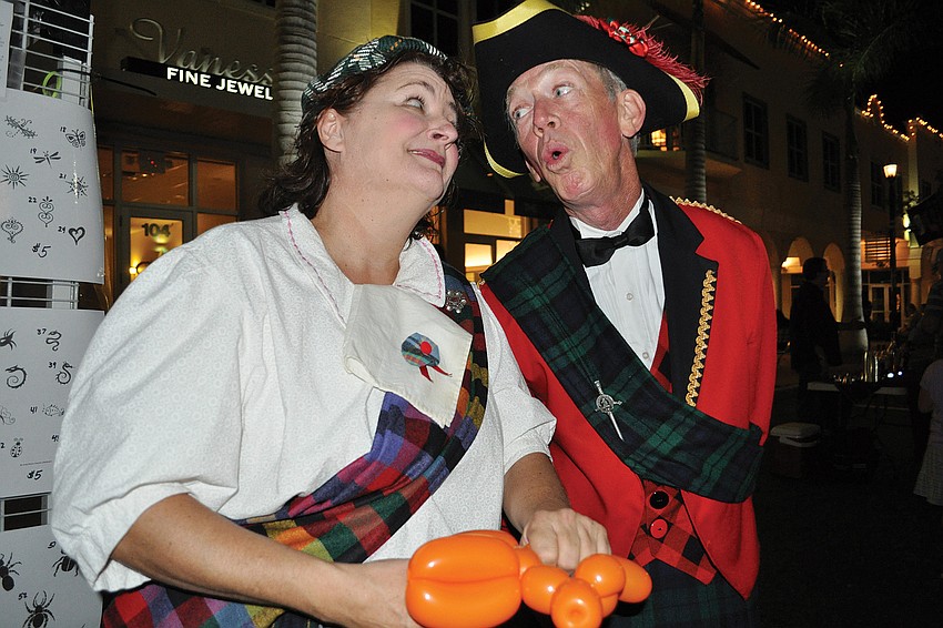Karen Bell enjoyed a song by Robin Eurich as she made balloon animals for guests during MacAllisters Grill & Tavern's annual Scottish St. Andrewâ€™s Festival Nov. 19. Published Nov. 24, 2011.