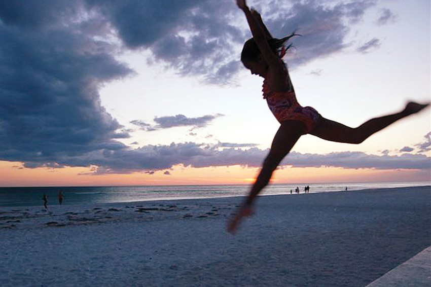 Tiny Dancer: University Park Country Club resident Giovanni DeCastro shot this sunset photo of his daughter, Emma, 8, Memorial Day weekend on Lido Beach.