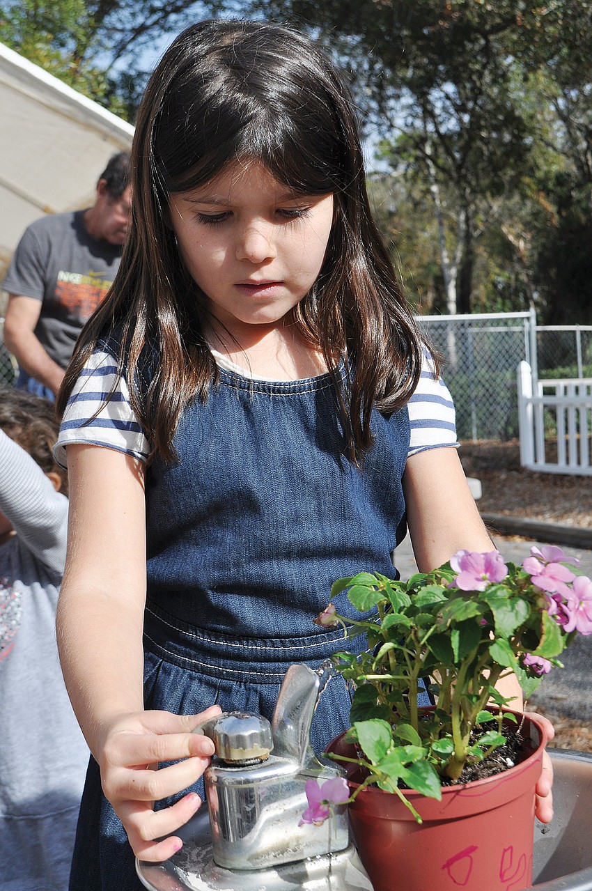 Riley Silva gave her plant some water in January at Temple Emanu-El Religious School.