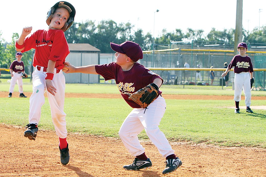 Owney Haney, No. 5, from Ball â€™Nâ€™ Shore tagged out Josh Fields, No. 11, from The Observer during the final game of spring season in May, at Twin Lakes Park.