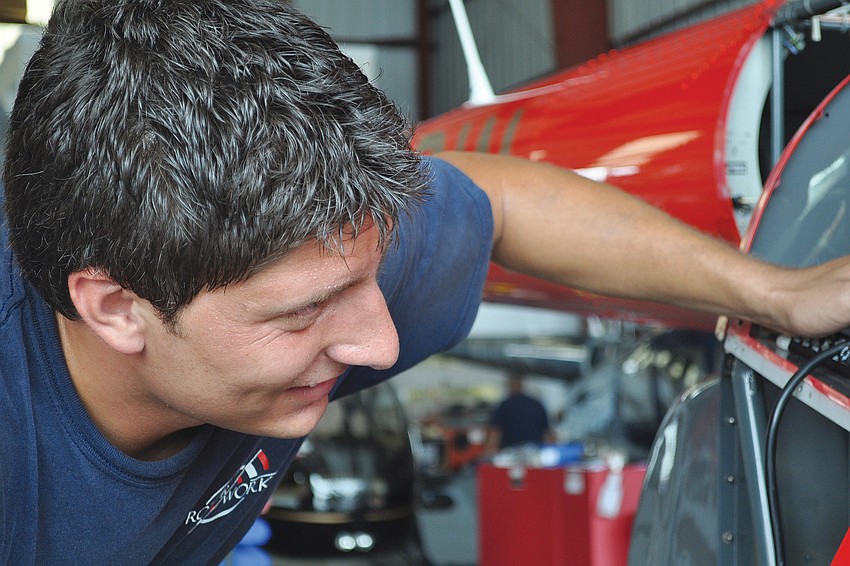 Airframe and power-plant mechanic Vess Ploskov removes the panels on an R44 Raven II helicopter thatâ€™s due for its annual inspection in August at the Sarasota-Bradenton International Airport.