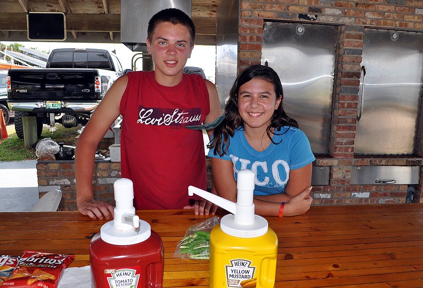 Chay Easton, 15, and Lillian Heredia, 11, worked the counter for the BBQ.