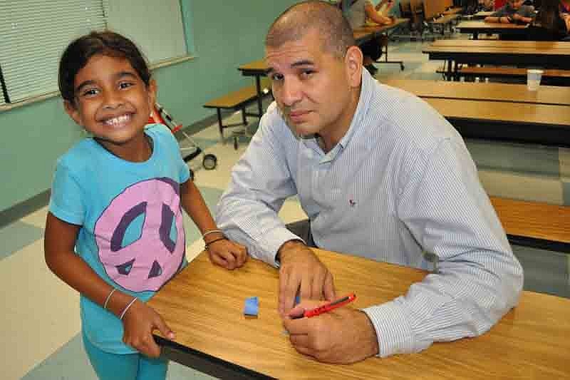 Emily Giraldo and her dad, Jamie, filled out raffle tickets.