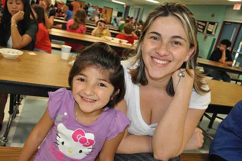 Gabriella Ramirez, 6, could not wait to get her picture taken with her mother, Luz.