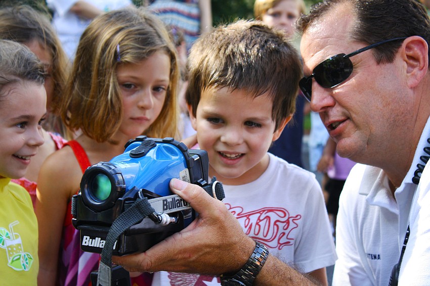 Lieutenant Scot Gottschalk shows Giovanna Hansen, Chloe Macaluso and Liam Lizotte the heat-seeking camera the department uses. He used their teacher to show what bodies look like.