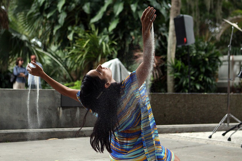 Leymis Bolanos Wilmott performs in the sand.