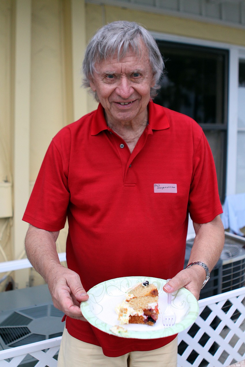 Phil Segerstrom gets a piece of cake to enjoy at the Golden Gate Pointe picnic.