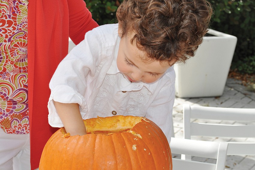 Adam Bomberger investigates a pumpkin. Photo by Mallory Gnaegy.