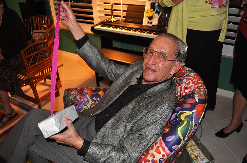 Bert Fivelson opens one of his gifts in the â€œgreen roomâ€.