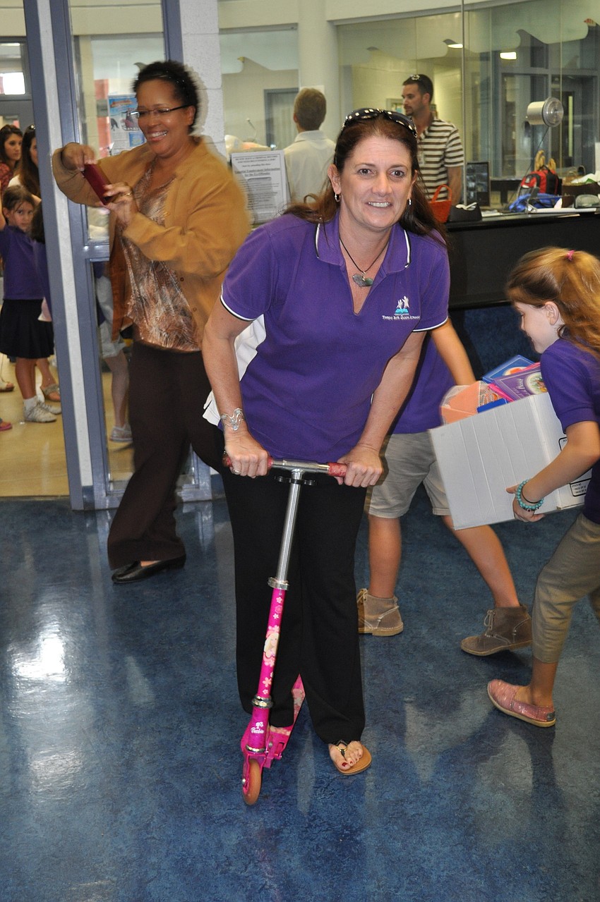 Teacher Barbara O'Brien speeds by on a scooter.