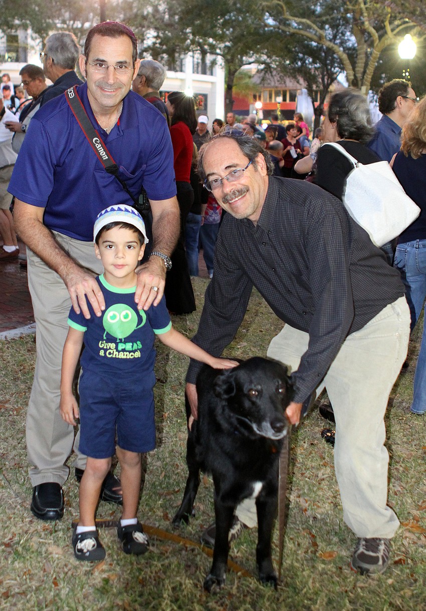 Ken Friedman with his son, Armando, 4, pose with Smokey and Harry Sumtur.