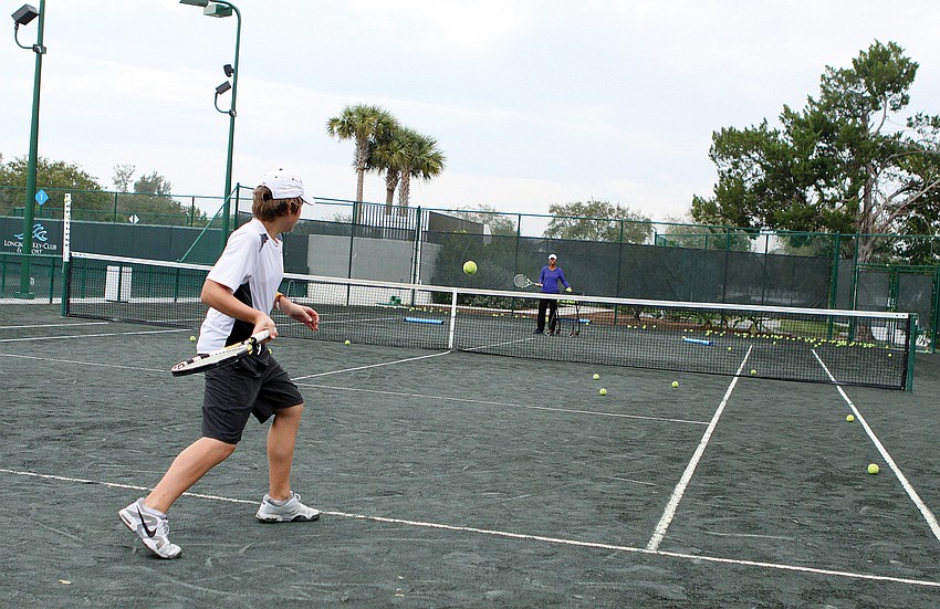 Phillip McCormick took tennis lesson in February from Longboat Key Club and Resort tennis pro Briana Harris.