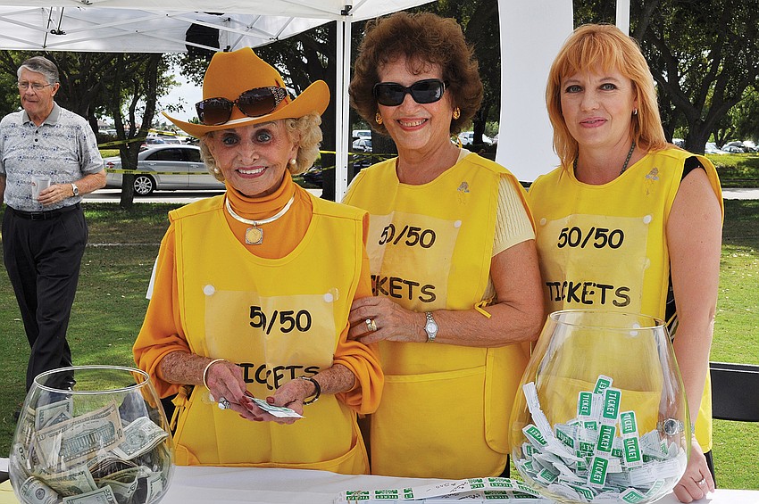 Edith Barr Dunn, Gosette Whiteneck and Olga Chepurko sold 50/50 raffle tickets at the Longboat Key Gourmet Lawn Party in November.