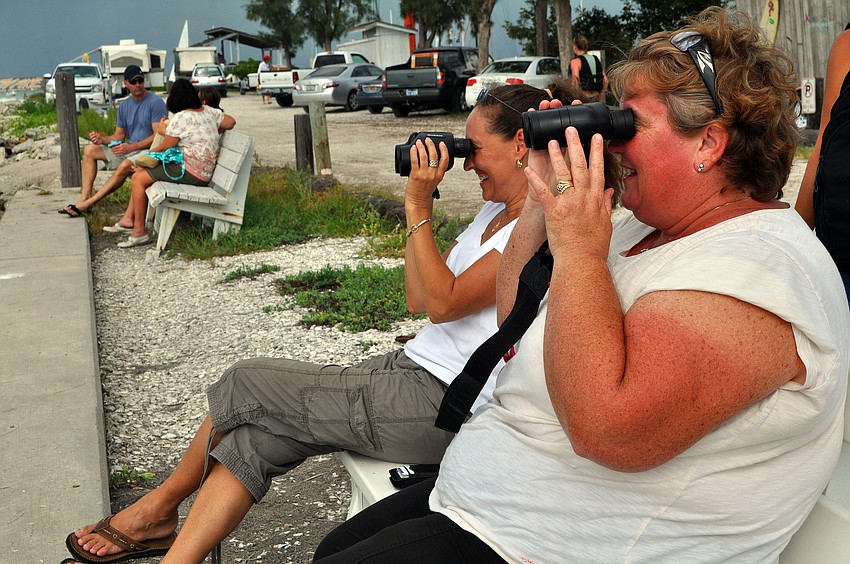 Lisa Gray and Deborah Ward look for their sons out on the water through binoculars Saturday, Sept. 3 at the 65th Labor Day Regatta at the Sarasota Sailing Squadron.