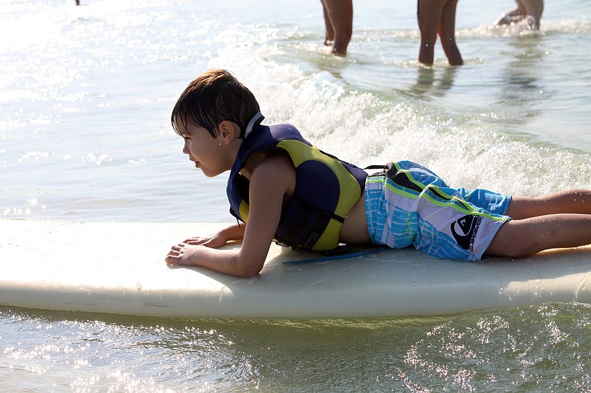Devin Kelly, 6, rides a wave in all by himself Saturday, Sept. 17, during the Hang Ten for Autism surf event at the Siesta Key Public Beach.