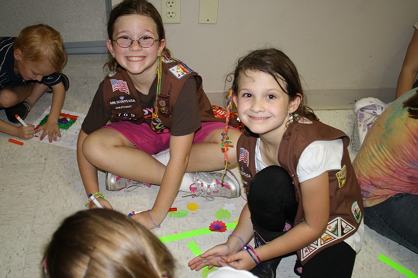 Annabelle Martin and Lily Dickens of troop 705 in Bradenton do crafts inside during the 100th anniversary kick off.