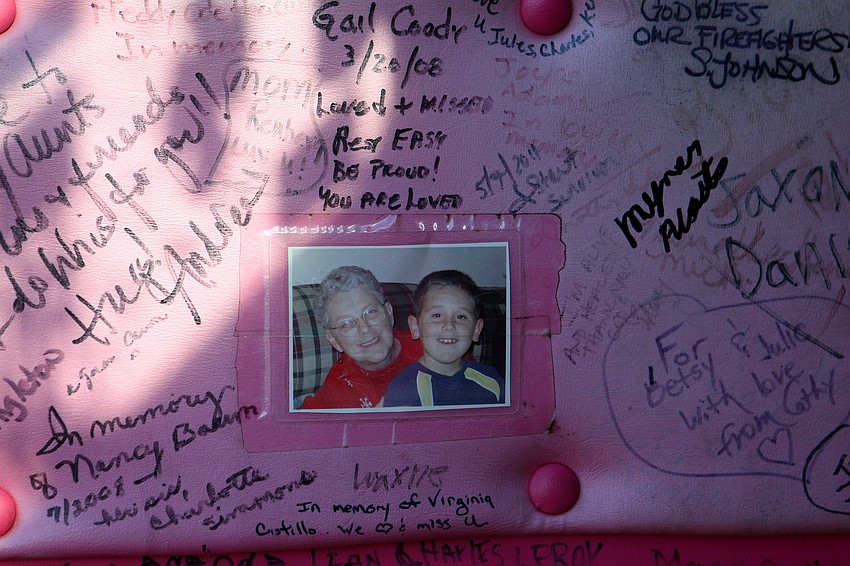 A photo is pasted inside one of the pink firetrucks' door along with tons of signatures and messages.