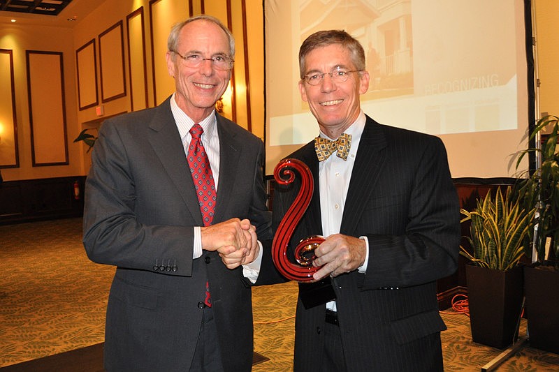 Neal Communities President Pat Neal is awarded the Business of the Year Award by The Observer Group Editor and CEO Matt Walsh.