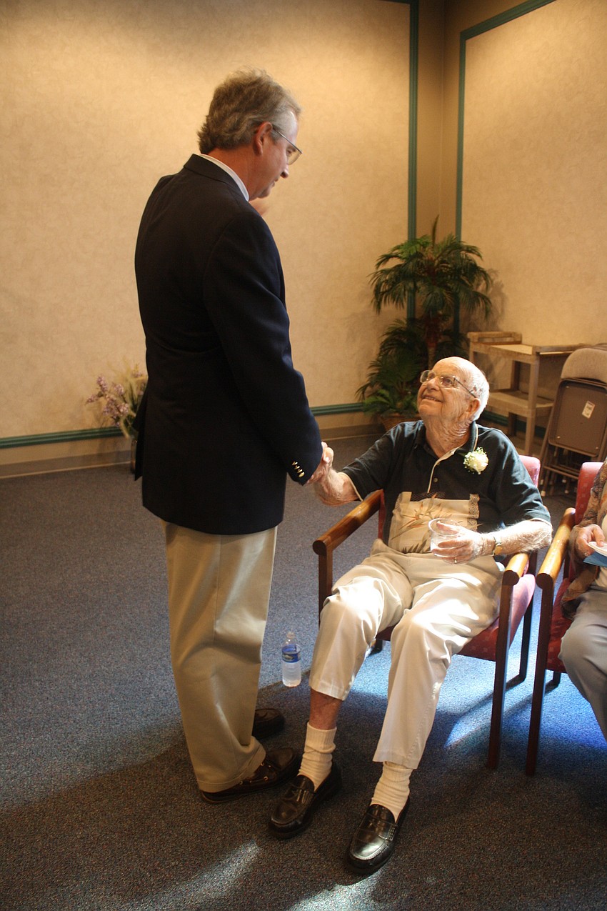 Former Town Manager Bruce St. Denis biding adieu to Jim Brown. St. Denis spoke at the Mass.