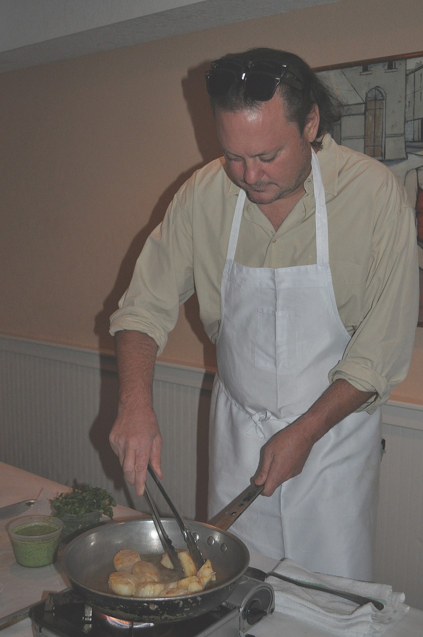 Tennis player Robert Seguso prepares scallops.