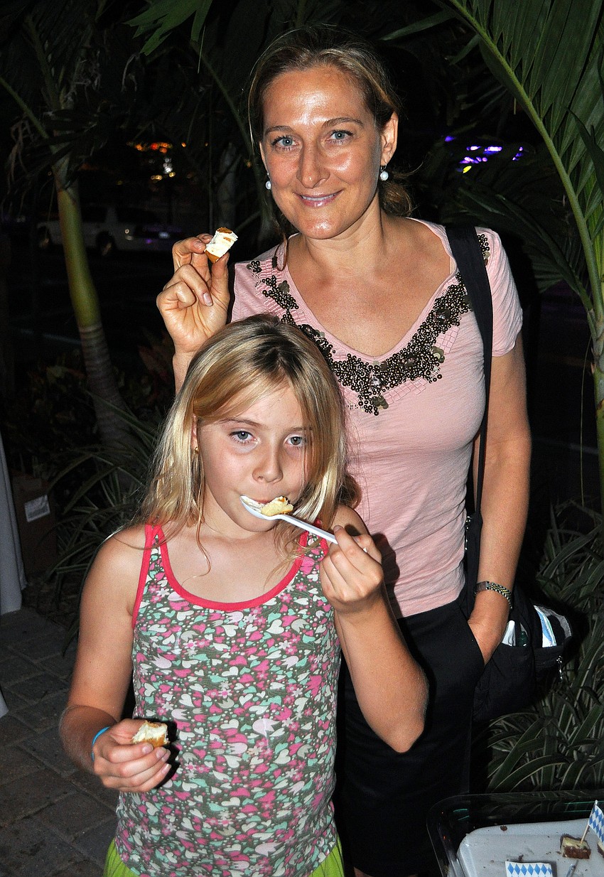 Catherine and Saylor, 8, Ellis enjoy some treats from the A Taste of Germany table Thurday, Oct. 6 during the 11th annual Okto-Paw-Fest at the Daiqiuri Deck on SIesta Key.