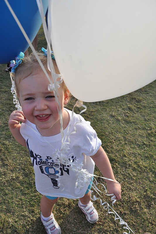 Carly Chapman, 2, played with balloons on her way to dinner.