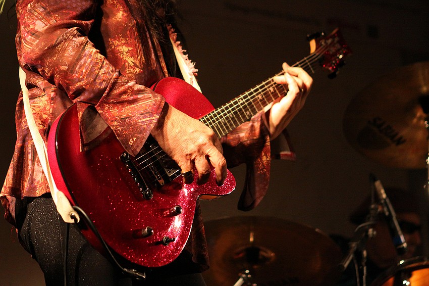 Jimi Gee strums his pink guitar while playing with Project SRQ Thursday, Oct. 14 during Dr. Idol at Michaelâ€™s on East.