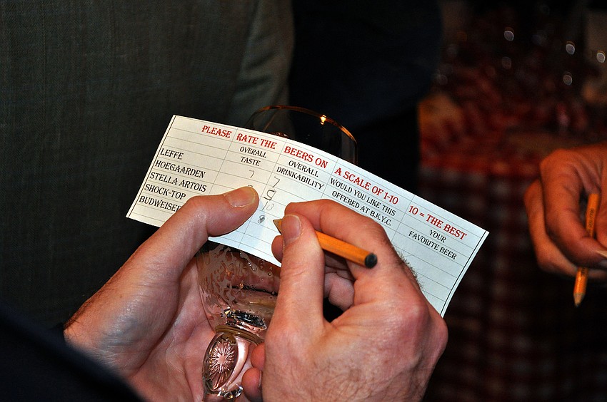 Tim Mahoney works on rating and voting on the different Belgian beers, Saturday, Oct. 22 at Bird Key Yacht Club.