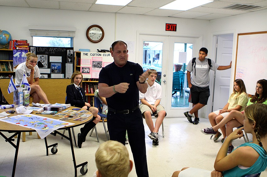 Marty Harberer talks to the students about Israel, Monday, Oct. 31, during International Children's Day at NewGate.