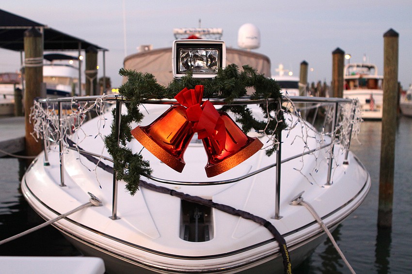 One boat had some garland and red bells on the bow of the boat as part of the holiday decorations.