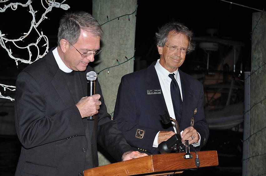 Rev. Fred Robinson blesses the fleet and Fleet Captain Allyn Carlson stands by.