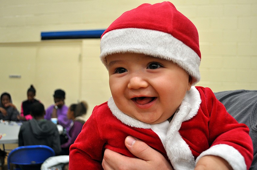 Cole Miller, 7 mos., was dressed in his very own Santa suit, Tuesday, Dec. 13, during Healthy Families Sarasotaâ€™s Holiday Party inside FirstBaptist Sarasotaâ€™s Family Life Center.