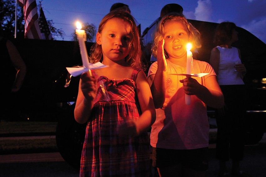 Alyssa Sparks, 4, and sister, Bryanna, 5, were among residents who honored Spc. 4 Patrick Lay II during a candlelight vigil Aug. 15. Lay, a Braden River High School graduate, was killed in an IED attack Aug. 11. Published Aug. 18, 2011.
