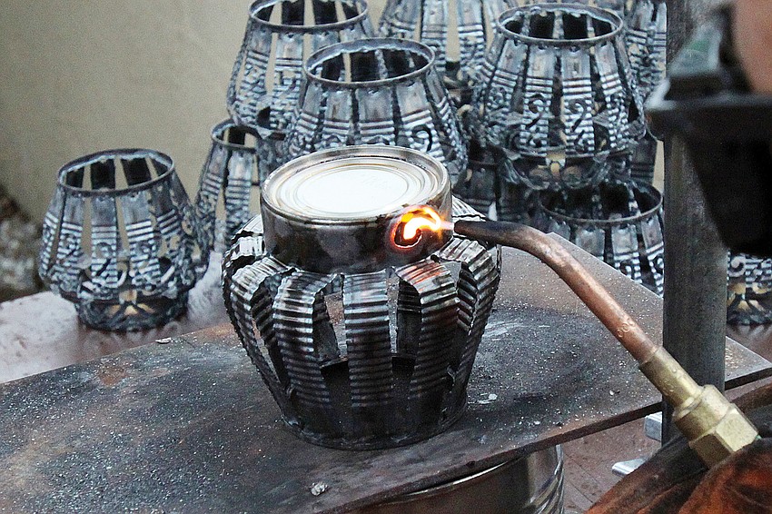 Leslie Dawley, of Aloe Tinnery, created decorative candleholders out of tin cans in February at the 17th annual Siesta Key Craft Festival.