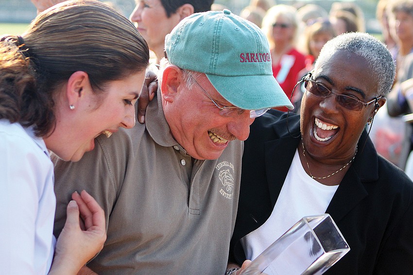 County Commissioners Christine Robinson and Carolyn Mason congratulate Norman Schimmel after he was surprised with the Voice of Tourism Award at the Sarasota Convention and Visitors Bureau 2011 National Tourism Week Awards Ceremony in May.