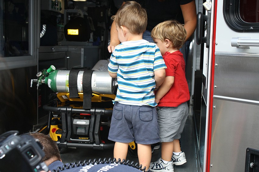 Andre Hersom and Cooper Nadell set-foot inside the ambulance. â€œThis is where people go when they get hurt,â€ Firefighter Paul Leverone tells the children.