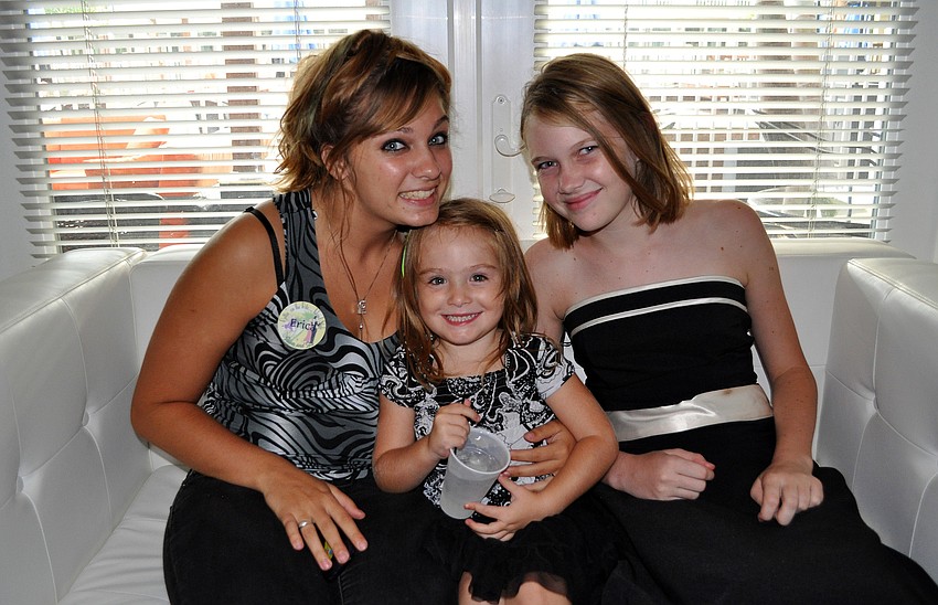 Erica Gustin, Emmah Thies, 4, and Elizabeth Bryant, 12, pose together on a couch at the combined chamber event Thursday, Sept. 22 at Bentley's Resort in Osprey.