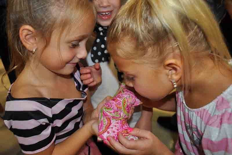 Corin Mohammadbhoy, 5, shows off the prize she won during the hula hoop contest to her friend, Hannah Hastreiter, also 5.