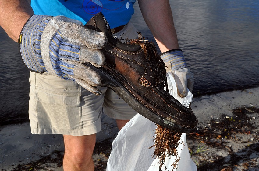 Robin Adair found a shoe while at Bayfront Park Saturday, Sept. 24, during the International Coastal Cleanup.