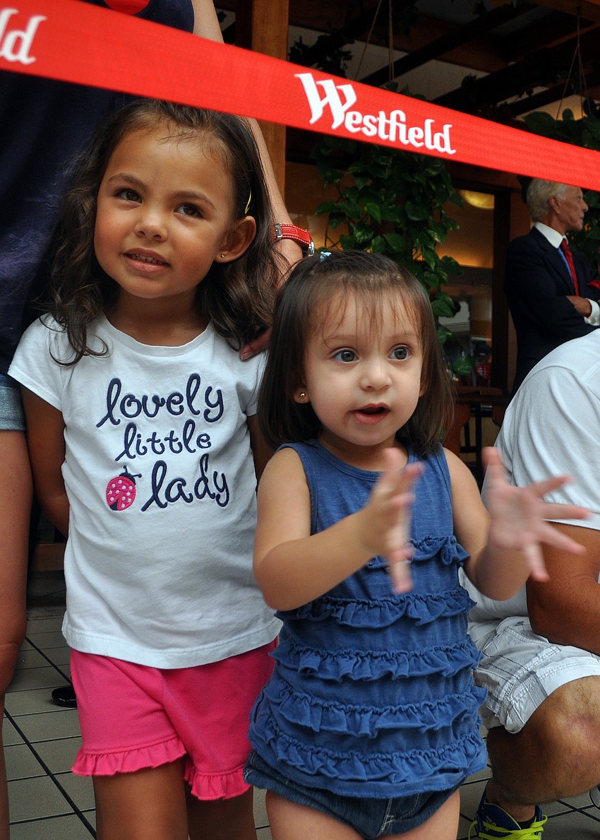 Eva Jeffries, 2, and Isabella Scheck, 21 mos., watch the dancers with great enthusiasm.
